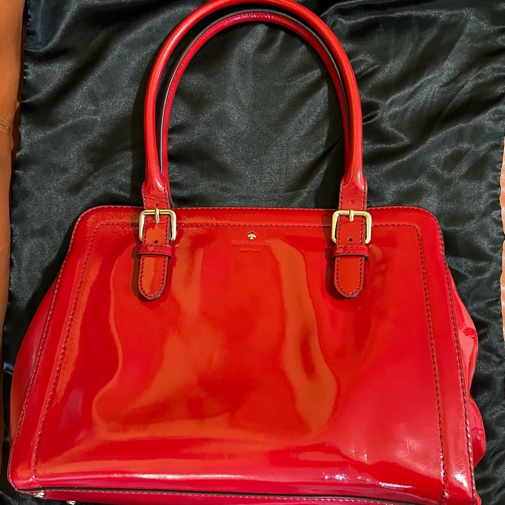 Kate Spade purse 14” width x 10” length. Used one time. No scratches or stains.